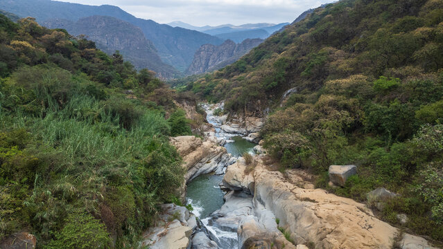 Panoramic aerial photo of the rocky river and crystal clear waters at the waterfalls, near the Laquipampa Wildlife Refuge, Lambayeque, Peru