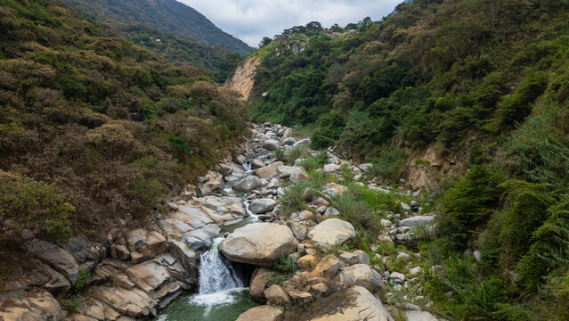 Panoramic aerial photo of the rocky river and crystal clear waters at the waterfalls, near the Laquipampa Wildlife Refuge, Lambayeque, Peru