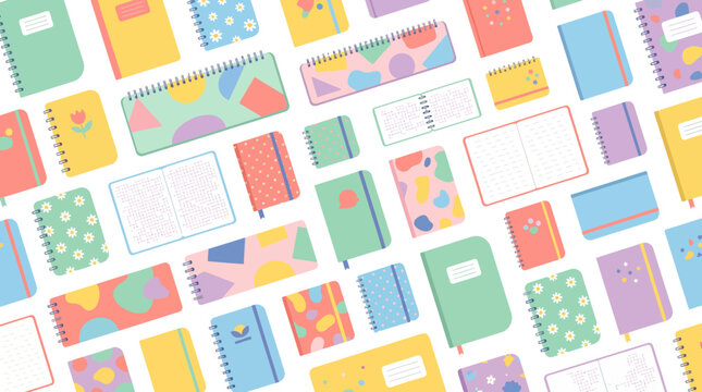 A vibrant overhead flat lay of numerous colorful notebooks and planners with various patterns and sizes scattered on a white background.