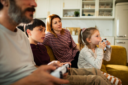 Family playing video games together at home