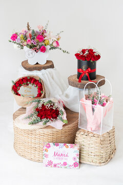 Mother's Day floral arrangement collection with rose bouquets displayed on wicker baskets with a greeting card.