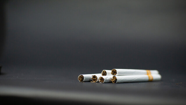 Cigarette butts isolated on black background