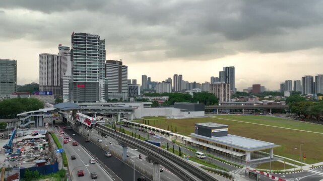 cloudy evening kuala lumpur city traffic street road metro skyline side construction aerial panorama 4k malaysia    