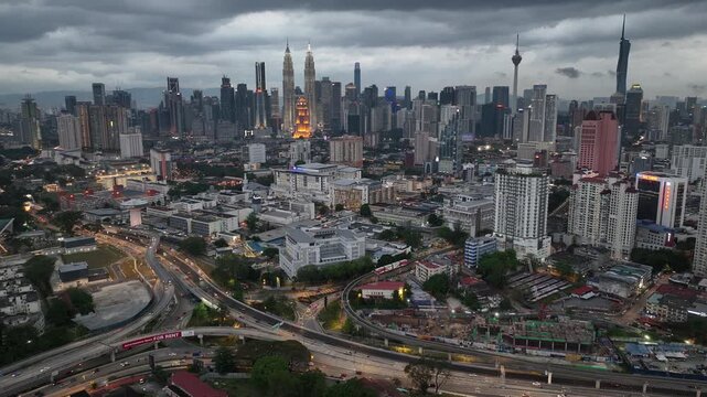 cloudy evening illuminated kuala lumpur city downtown traffic street road interchange aerial panorama 4k malaysia    