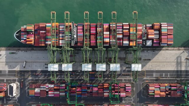sunny day singapore city port terminal container ship loading working cranes bay aerial topdown panorama 4k    