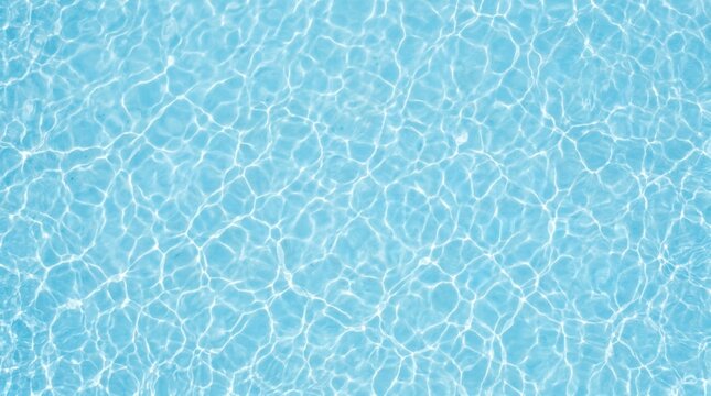 Top down view of crystal clear light blue water surface with gentle ripples and beautiful caustic light reflections