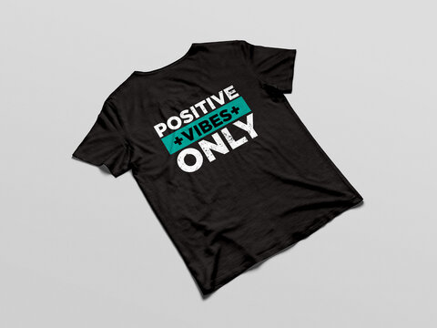 A high-quality black t-shirt mockup featuring a modern minimalist typography design with a vintage grunge texture. The graphic text states the popular motivational phrase "Positive Vibes Only" using b