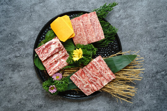 Top view of premium raw marbled wagyu beef slices on a plate