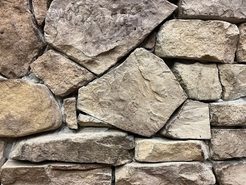 Natural Stacked Fieldstone Wall Texture for Rustic Landscaping. Fieldstone rustic wall for interior design. Full frame of Handcrafted Natural Stone for Decoration.