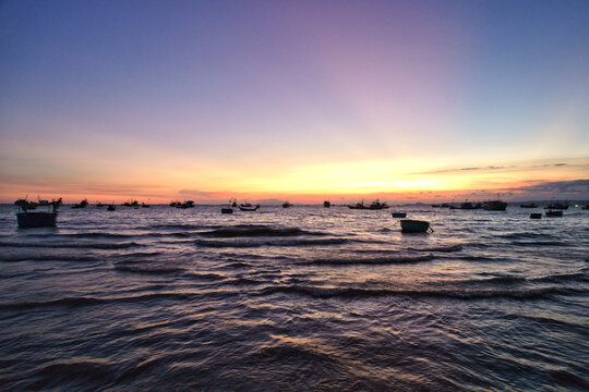 Beautiful sunset over fishing boats in Mui Ne Vietnam