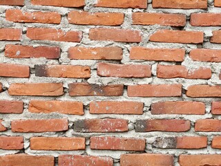 Fototapeta premium Close-up View of a Weathered Red Brick Wall Texture.