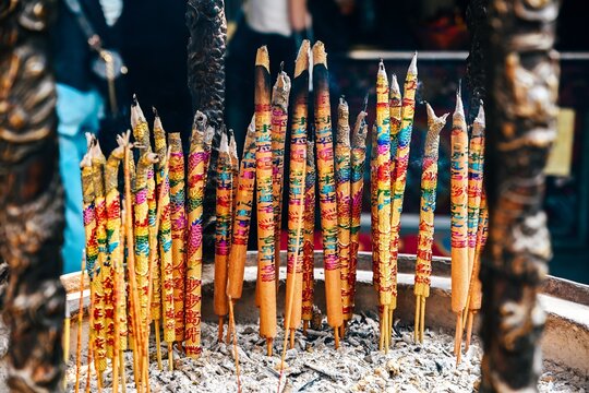 Close up of burning colorful joss sticks with auspicious characters meaning blessing and peace at ancient a ma temple landmark in Macau China
