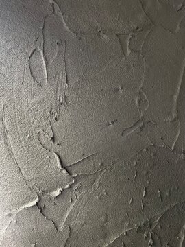 concrete wall texture, Close-up texture of a rough concrete wall with visible trowel marks, imperfections, and a raw, industrial loft style surface.