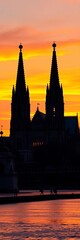 Fototapeta premium Gothic cathedral silhouette with twin spires at sunset, ||towering architecture, evening sky