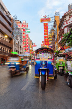 Blue tuk-tuk parked on Yaowarat Road at Chinatown of Bangkok