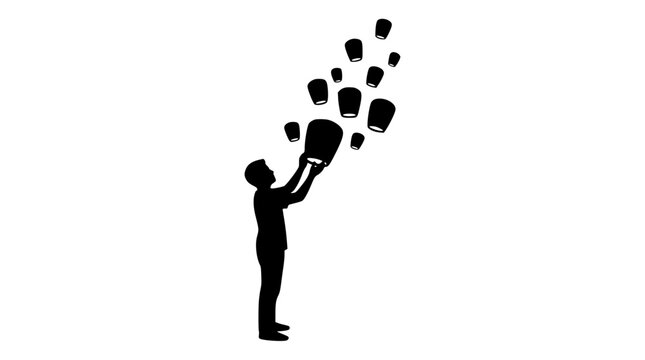 silhouette of a person releasing sky lanterns into the air