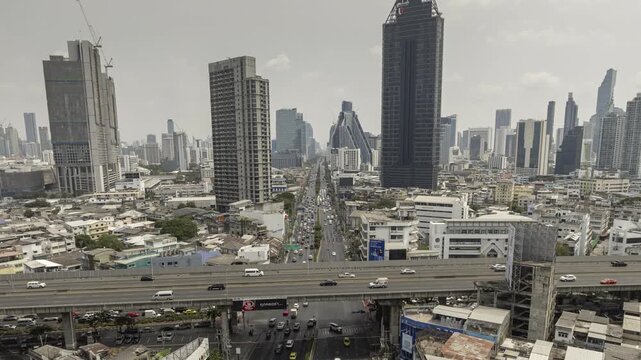sunny day flight over bangkok city traffic street crossroad overpass aerial panorama 4k timelapse thailand
