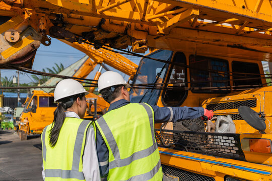 Engineer inspecting crane safety compliance worksite regulation