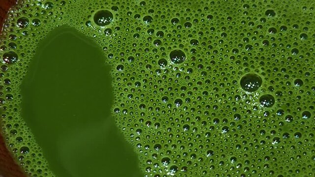 The process of brewing matcha green tea.