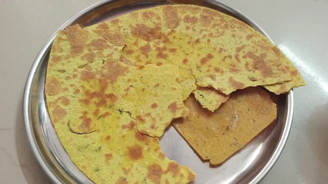 Broken Crispy Indian Khakhra Bread in a Steel Plate