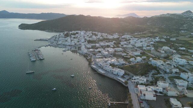 Drone flight during sunset over the village of Pollonia in the Island of Milos, Greece revealing the greek scenery