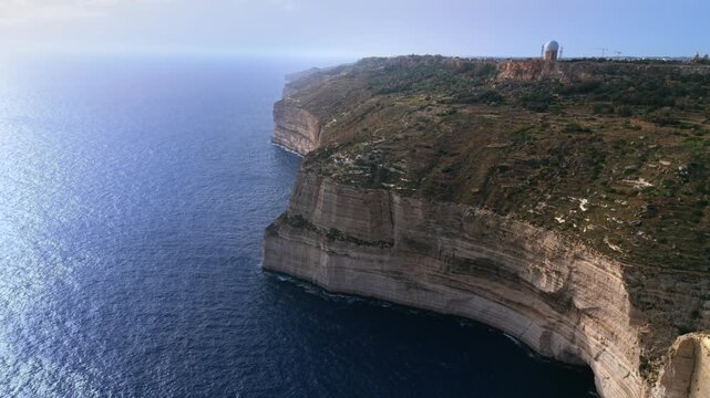 The Dingli Cliffs form a massive natural wall along Malta's isolated western coast, representing the highest point of the Maltese islands at over 250 meters above sea level.