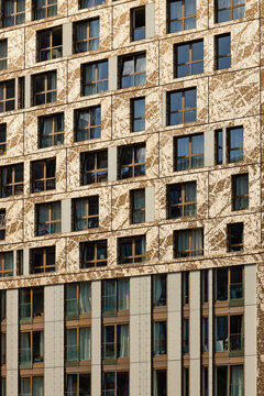 View of the modern facade of a residential building with a decorative gold pattern and numerous windows Rotterdam, South Holland, Netherlands.