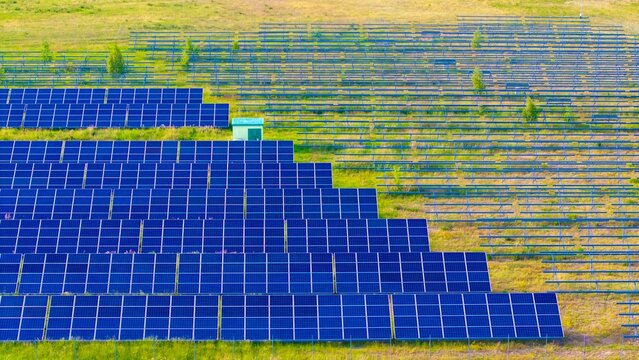 Newly installed solar panels in a renewable energy field, view of racked solar panels in a field, installing new power needed to generate energy from the sun.