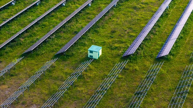 Newly installed solar panels in a renewable energy field, view of racked solar panels in a field, installing new power needed to generate energy from the sun.