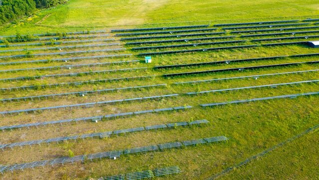 Newly installed solar panels in a renewable energy field, view of racked solar panels in a field, installing new power needed to generate energy from the sun.
