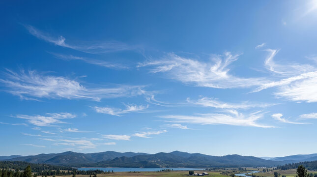 Clear sky with wispy contrails over rolling mountain horizons clouds blue
