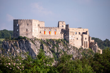 Fototapeta premium Beckov Castle ruins perched on a limestone cliff above the Váh Valley in Slovakia. Historic medieval fortress, landmark and popular travel destination surrounded by nature.