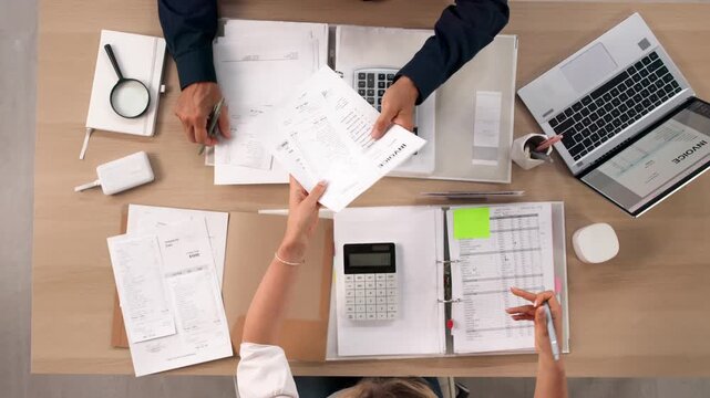 Business Advisor Carefully Reviews Invoices