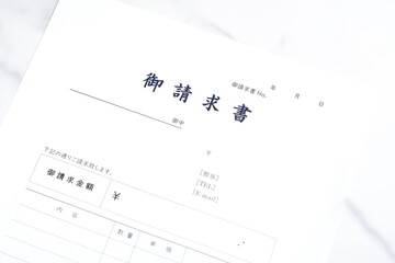 御請求書 - 取引先へ宛てて請求書を準備する、ビジネスシーンのイメージ  © PJM