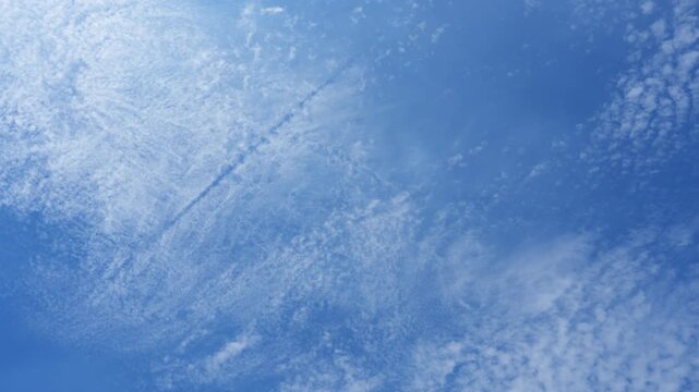A blue sky timelapse video featuring delicate Cirrocumulus clouds and faint cloud bands drifting across the upper atmosphere, symbolizing innovation, limitless potential, and forward-thinking vision.
