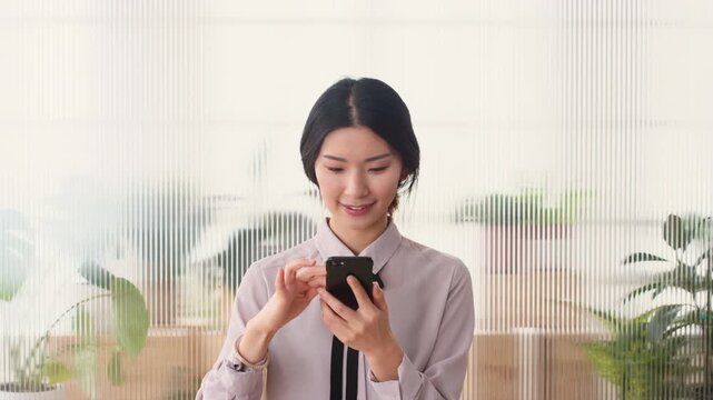Phone, smile and business woman in office for financial notification, email update or feedback. Mobile, scroll and Asian person in company for message, investment app or consultant reading text