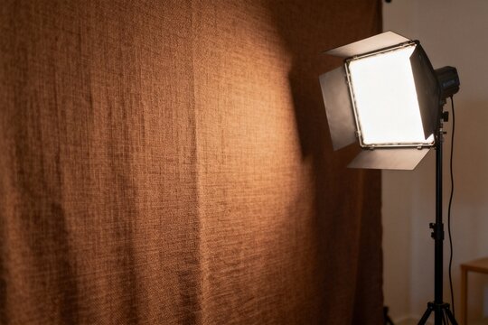 Studio lighting setup with warm backdrop for photography