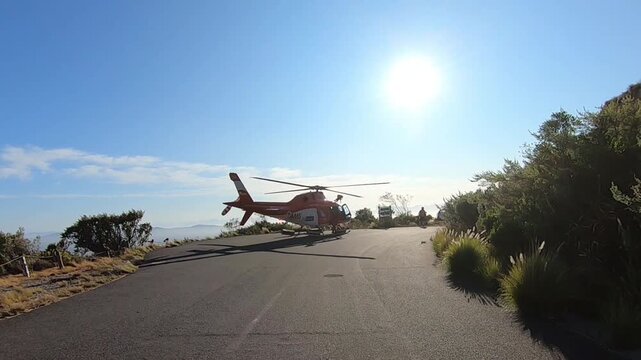 AMS Chopper (Air Ambulance and Rescue Helicopter) on road. Handheld footage