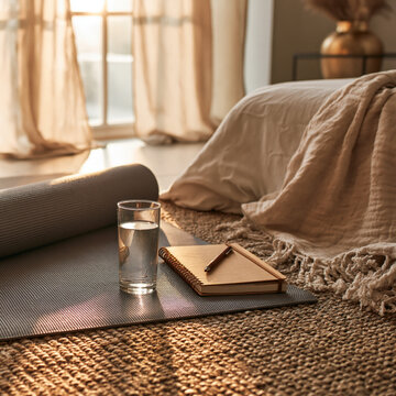 Sunrise morning routine with open curtains warm sunlight stretching mat water glass and journal for circadian wellness lifestyle