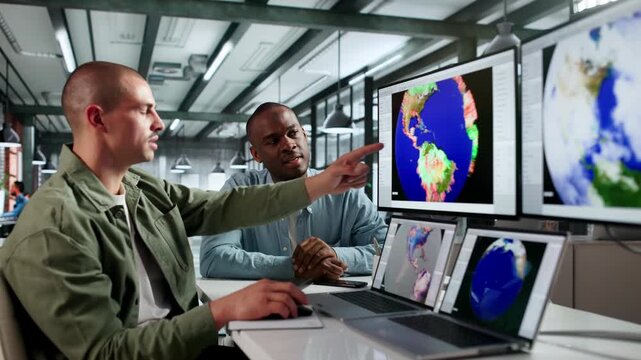 Meteorologists Analyzing Climate Data On Computers