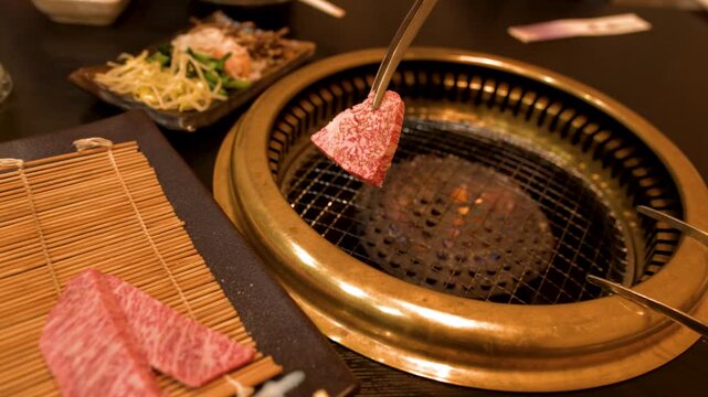 Raw Wagyu Beef Slices Placed on Hot Japanese Yakiniku Grill