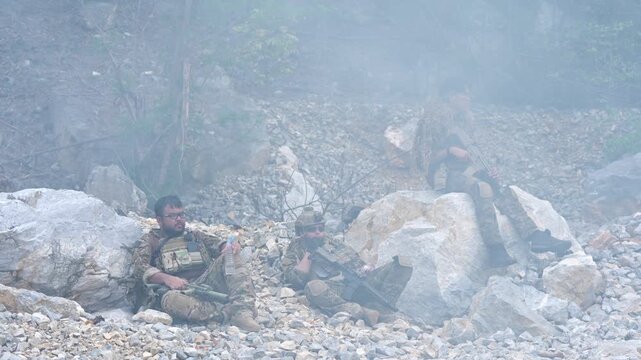 Soldier takes cover amidst smoke battlefield photo collection war zone ground level survival instincts