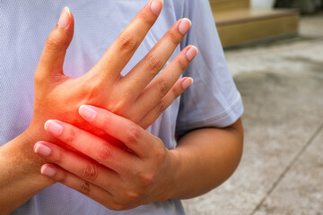 Fototapeta premium Closeup of athlete gripping painful palm, sports hand injury photo highlighting medical diagnosis, treatment, therapy, and healthcare use.