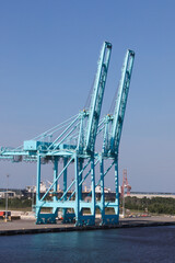 Obraz premium Massive Industrial Port Gantry Cranes at Shipping Container Terminal