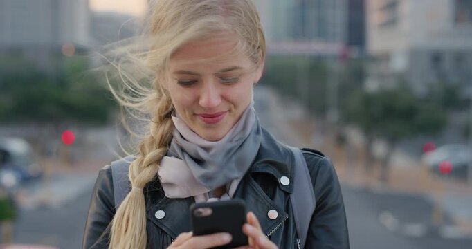 Phone, student and woman outdoor, smile and text message for education course on internet. Mobile, reading and person in city with academic app, development and scroll post for update with wind