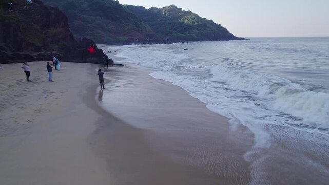 Aerial view of beach waves and hills creating scenic coastal landscape with natural beauty
