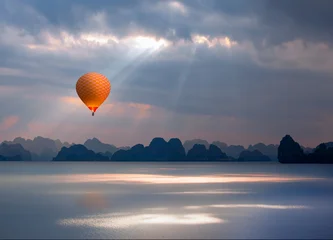 Hot air balloon flying over Ha long Bay Sunset in the morning on the harbour - Vietnam © muratart