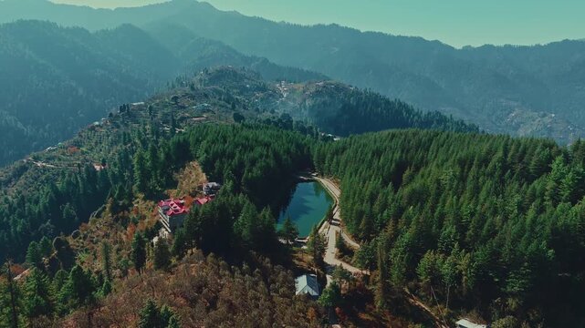 Aerial view of tai jubbar lake nestled in dense pine forest in shimla, Himachal pradesh.
