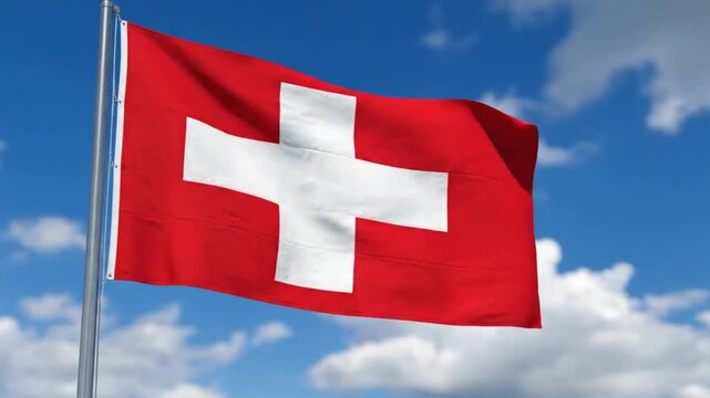 Swiss flag waving against a blue sky with clouds