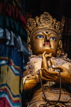 Interior of Gandantegchinlen Monastery featuring a close up of the giant Avalokiteshvara statue (Buddha statue) in Ulaanbaatar, Mongolia.